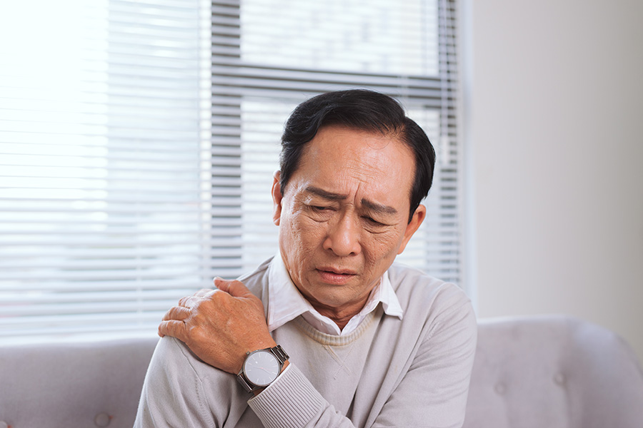 Elderly man suffering from shoulder pain